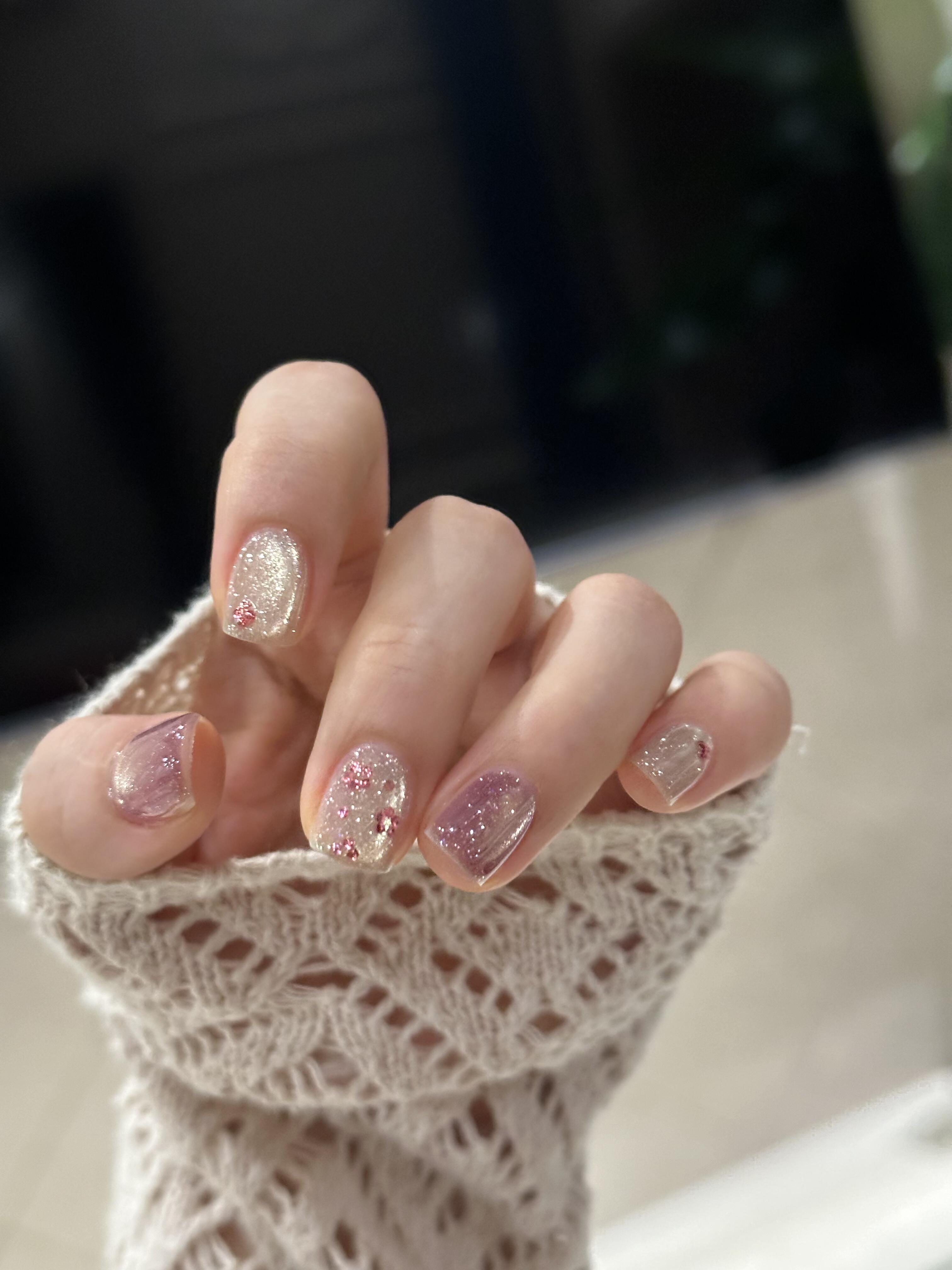 Nail designs tools flat lay including brushes, gel polish bottles, and UV lamp on a white surface