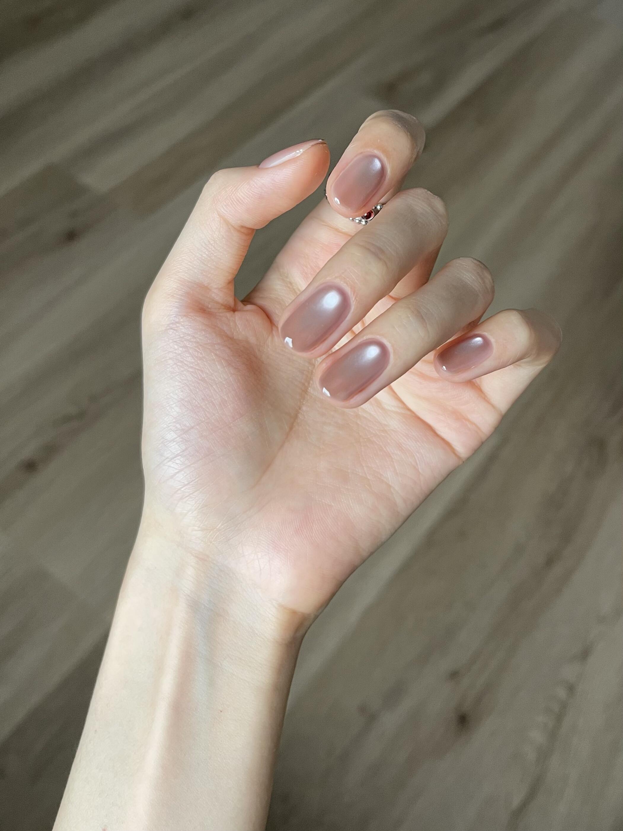 Clean minimalist nail designs with single arc line art on a nude base